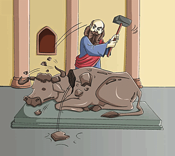 Man is iconoclastic with a hammer as he breaks a bull icon to pieces.